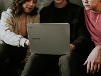 3 persons using a chromebook interactively